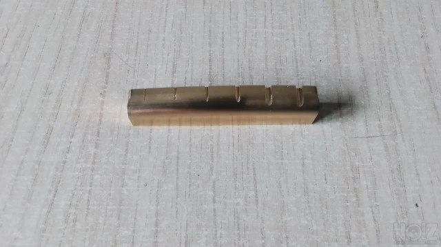 Guitar bone nuts and brass