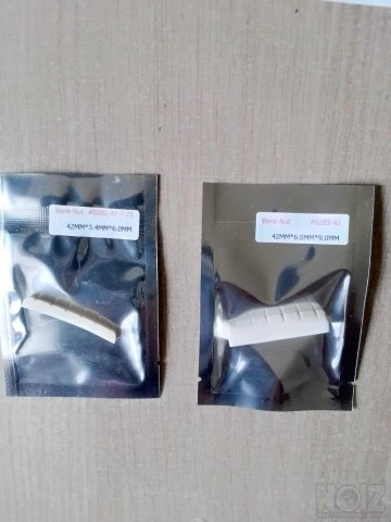 Guitar bone nuts and brass